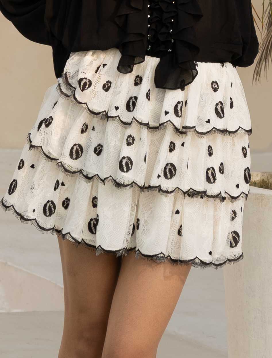 Off-white tulle ruffled skirt showing scalloped tiered hem