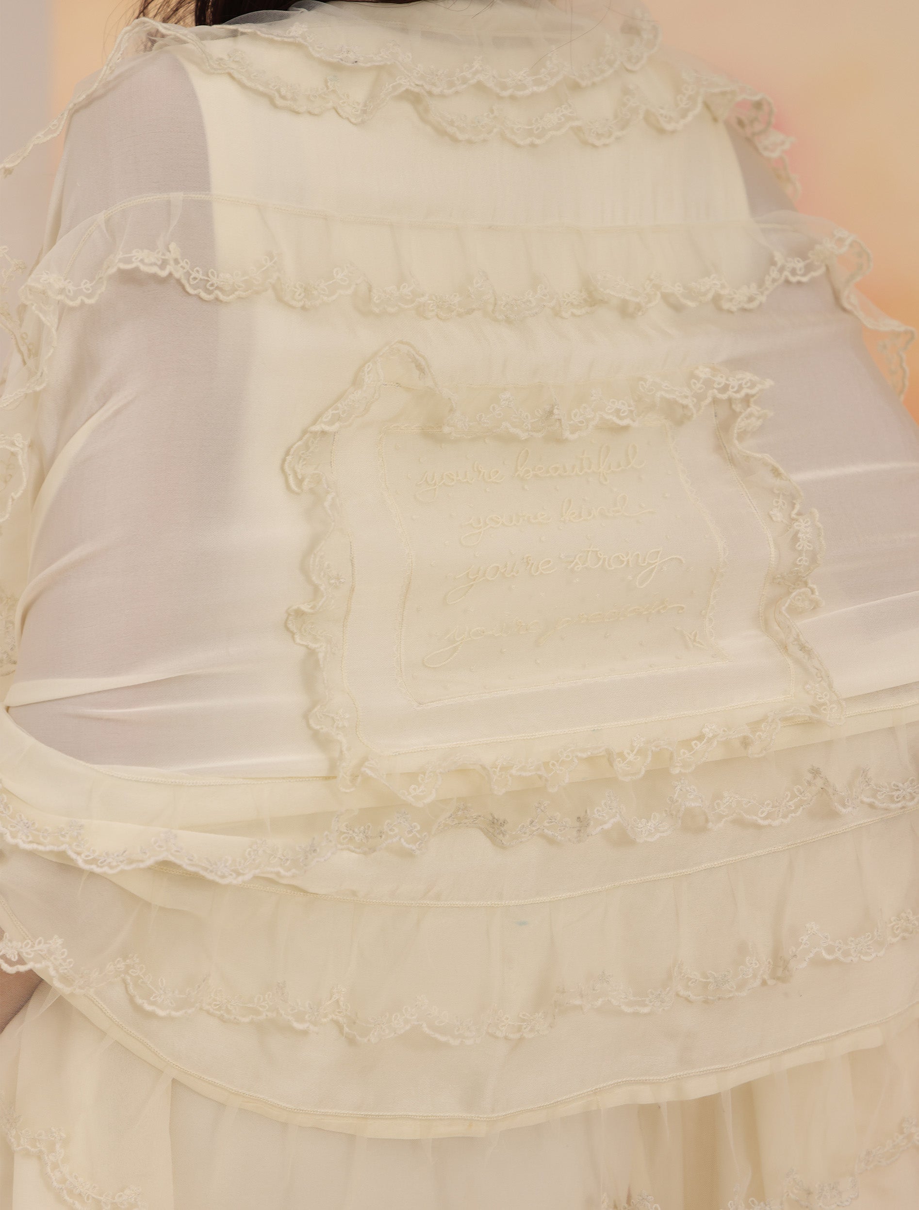 Ruffled Scarf - Cloud Dancer showing embroidered back panel and ruffle detail