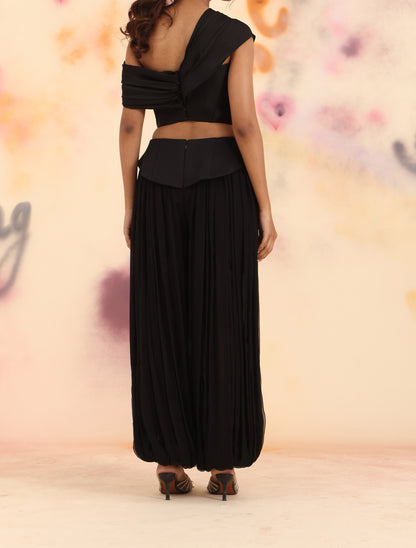 Back view of black Sculpt Dhoti Pants showing draped gathers and tapered hem