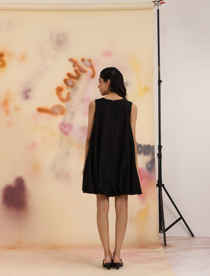 Back view of black Cloud Hem Embellished Dress with relaxed drape